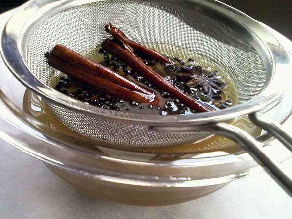 Spiced Simple Syrup being strained.