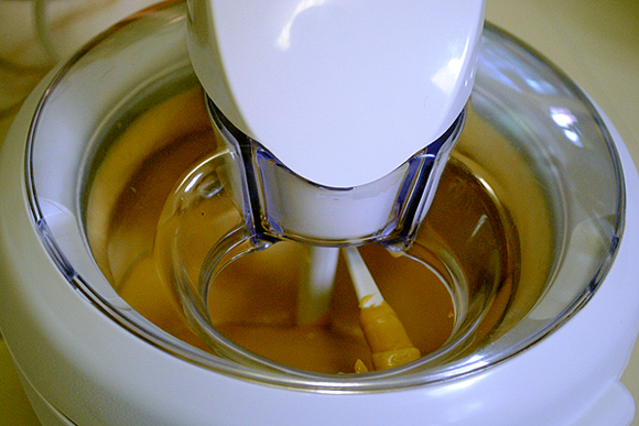 White Chocolate Peanut Butter Yogurt Ice Cream churning in an ice cream machine.