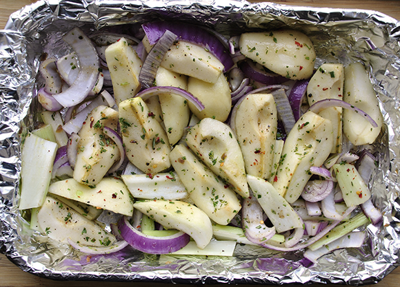 Uncooked pears and vegetables in the baking dish
