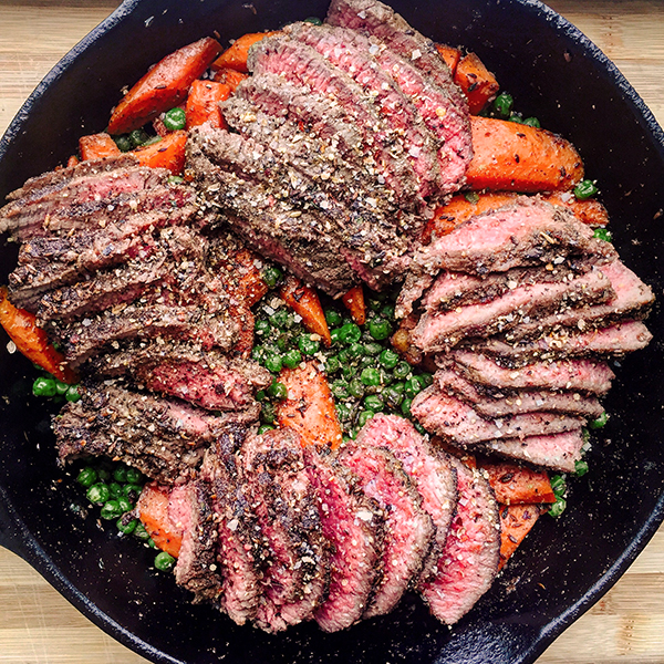 Cumin top sirloin steak with peas and carrots